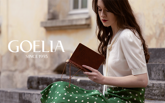 A lady looking at the book wears a green skirt.