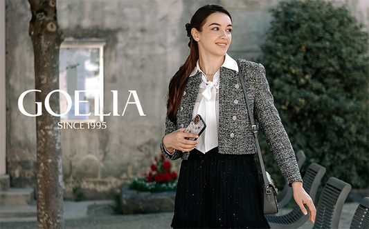 A lady wears a grey blazer and a black skirt.