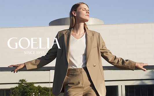 A lady wears an oversized blazer and a white top.