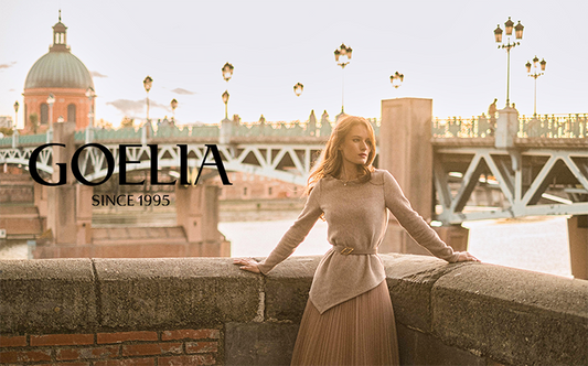 A lady wears a beige tulle skirt and a belt.