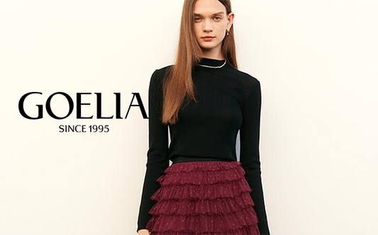 a lady in black sweater with burgundy mesh skirt