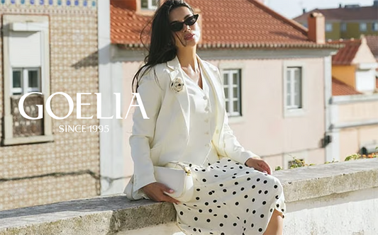 a lady wears a beige blazer and a polka dot printed midi skirt 