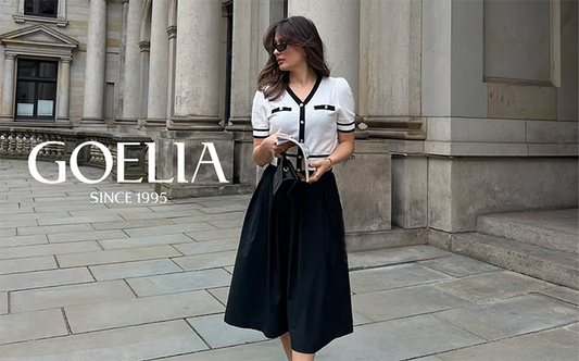 a lady in white cardigan with black midi dress 