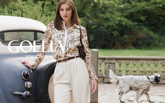 a lady wears a floral printed shirt with white pants 