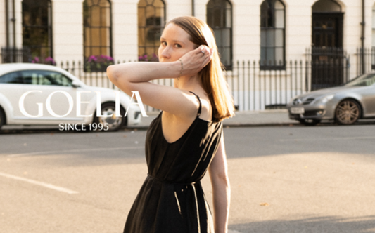 a lady in a black slip wrap dress