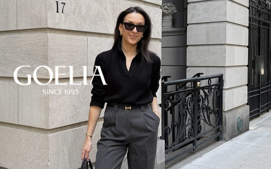 a lady in a black shirt and a pair of gray pants