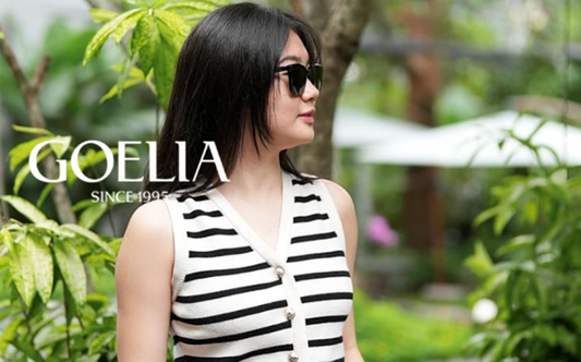 a lady in a striped knit vest and a pair of black shorts