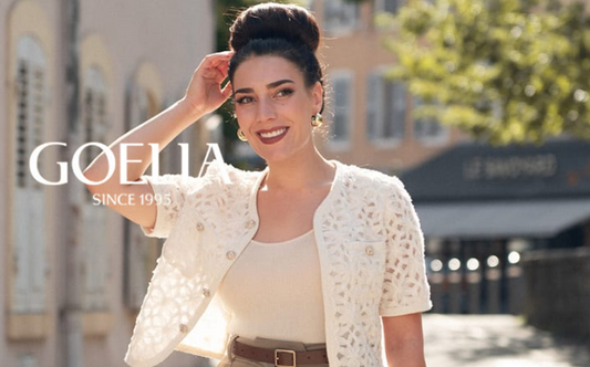 a lady in a beige crop top, a white openwork jacket and a pair of brown pants