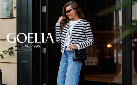 a lady in a white top, a striped cardigan and a pair of jeans