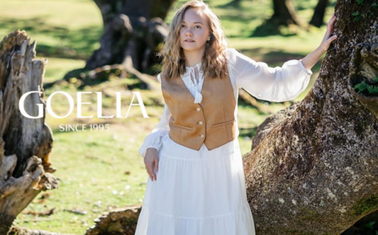 a lady in a white dress and a yellow vest