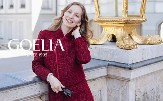 a lady in a red tweed like jacket and skirt two-piece set