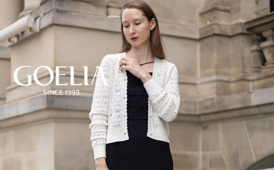 a lady in a black sleeveless dress and a white openwork cardigan