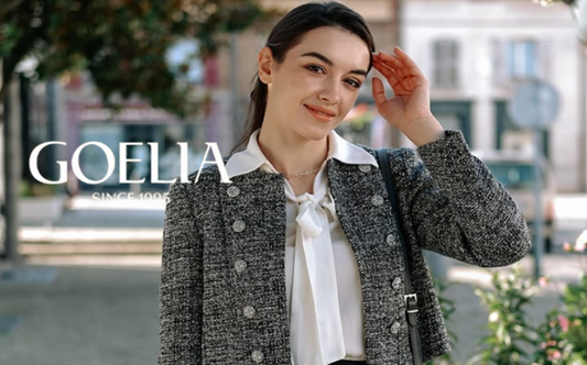 a lady in a white shirt, a grey tweed jacket and a black tulle skirt