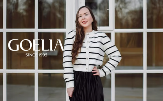 a lady in a striped knit top and a black velvet skirt