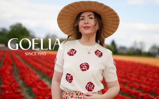 a lady in a red rose jacquard top and a floral skirt