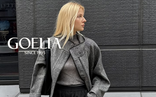 a lady in a grey top, a grey wool coat and a pair of black slacks