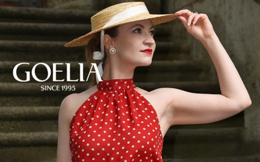 a lady in a red top and a white skirt with polka dots