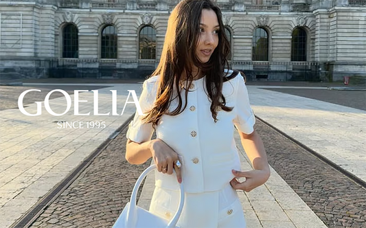 a lady wears a white tweed cropped jacket with matching shorts 