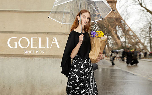 a lady wears a black top with a floral printed skirt 