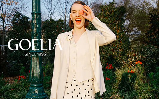 a lady in white blazer and polka dot midi skirt 