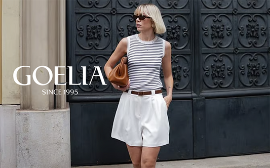 a lady wears a striped tank top with white shorts 